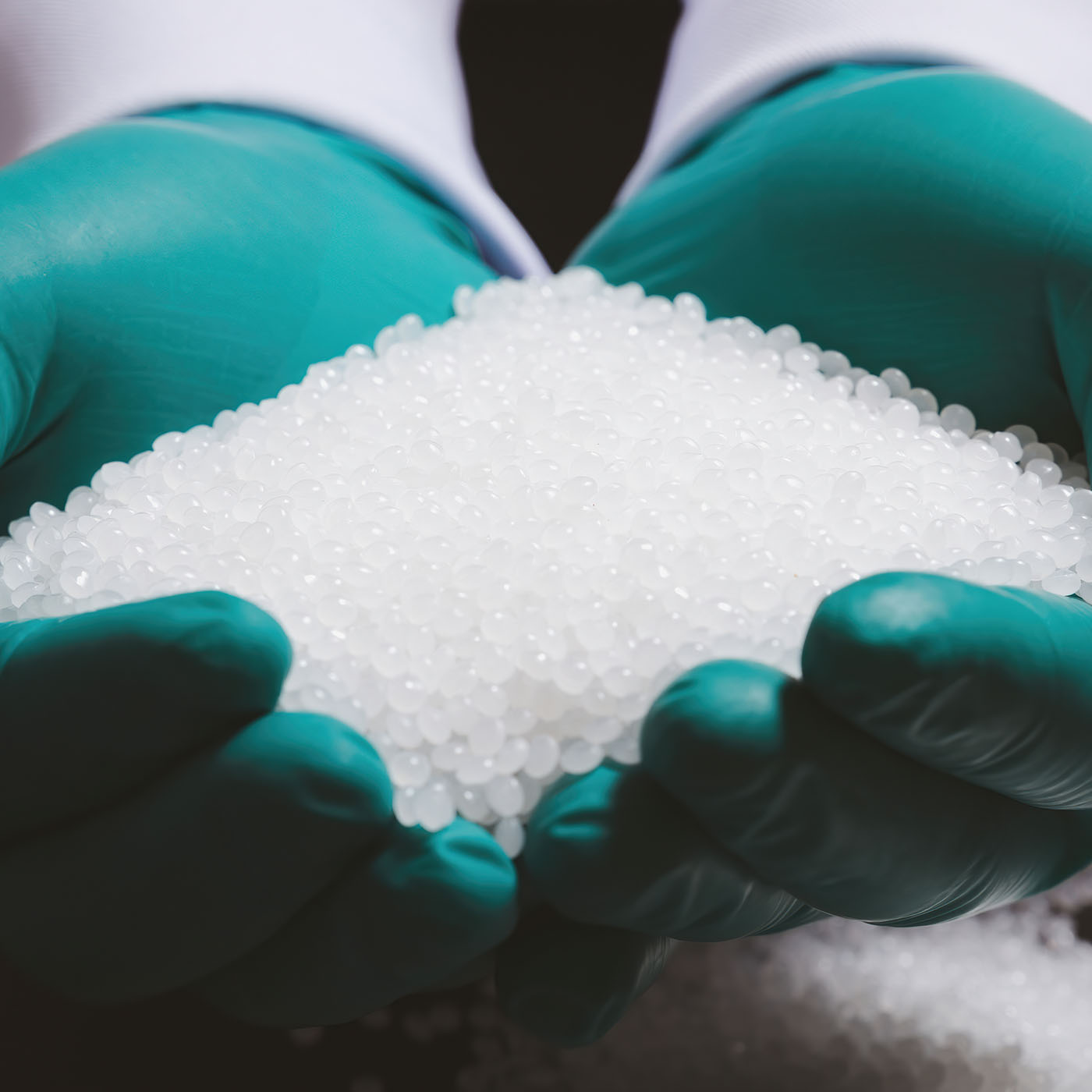 hands holding plastic pellets-2030105051-sqcrop1 hands holding plastic pellets-2030105051-sqcrop1